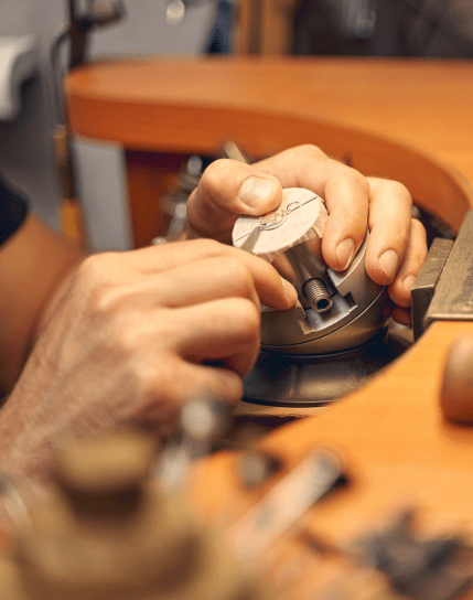 man engraving jewelry